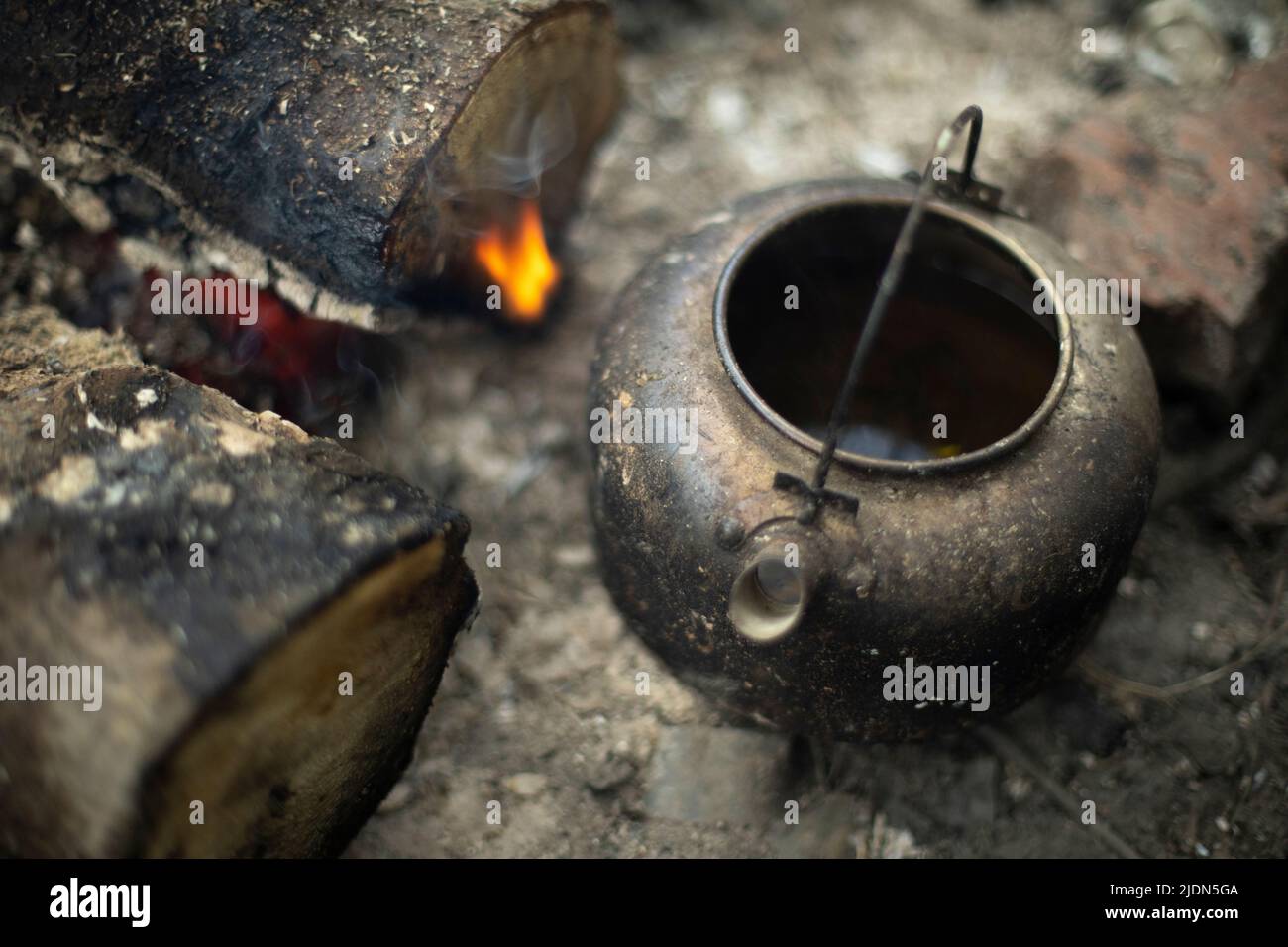 Kettle with water heated on the fire Stock Photo - Alamy