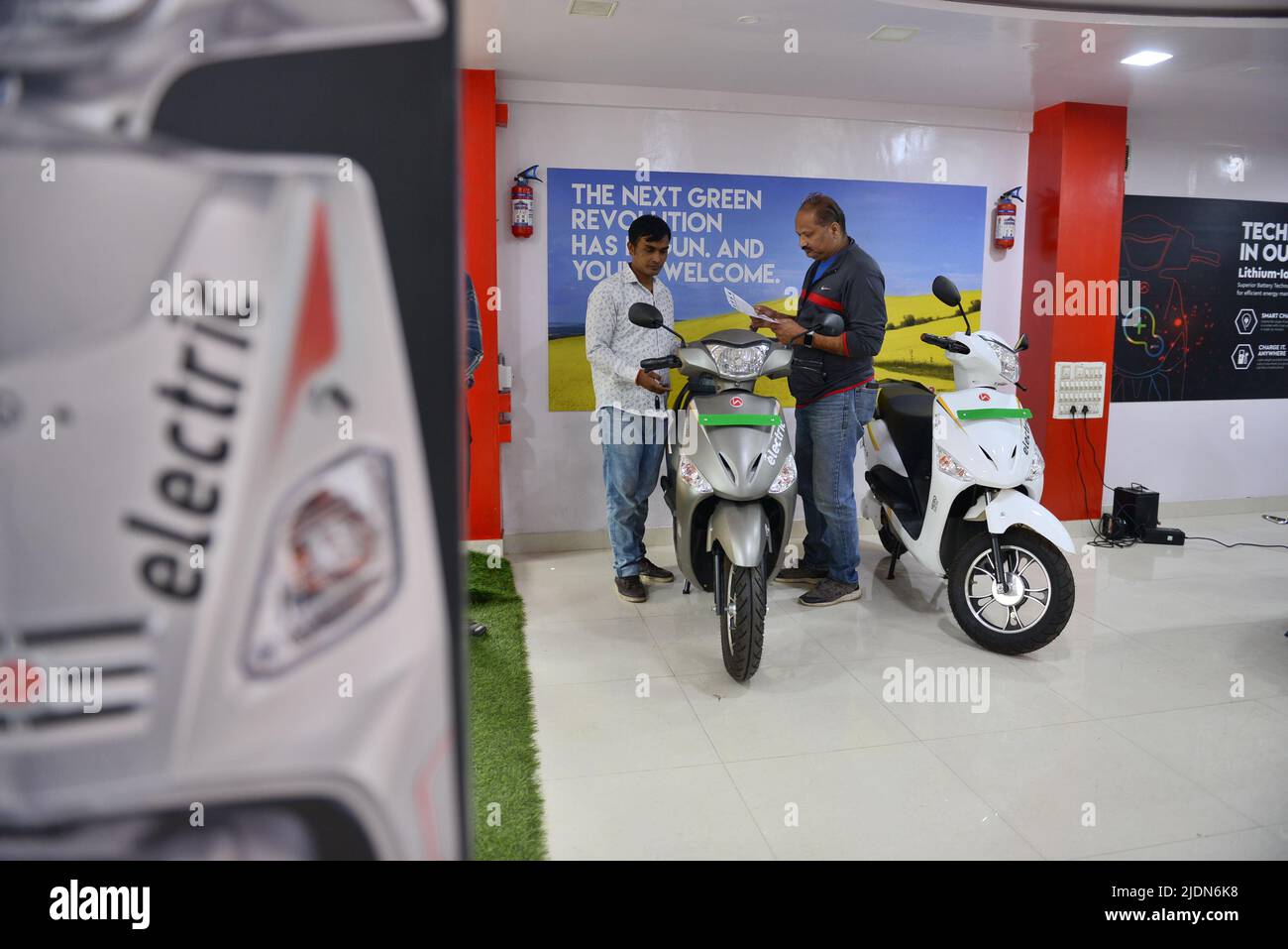 A salesman attends to a costumer at the Hero Electric Showroom. Hero