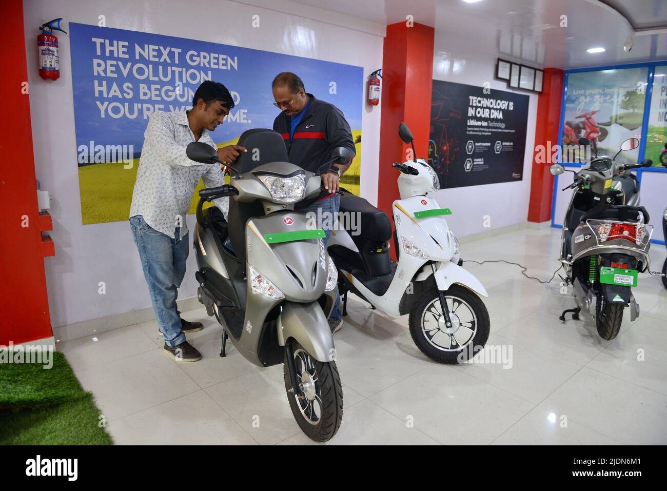 A salesman attends to a costumer at the Hero Electric Showroom. Hero