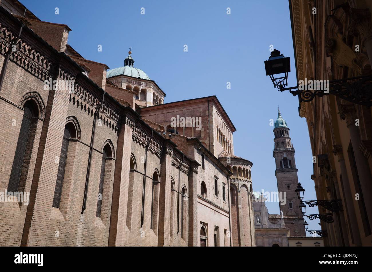Side wall of Parma Cathedral and bell tower of Church of San Giovanni Evangelista also known as Abbazia di San Giovanni Evangelista. Vintage lanterns Stock Photo