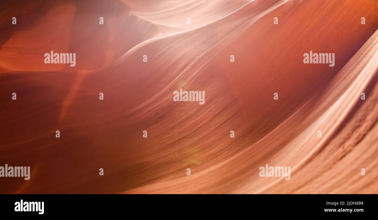 Red orange shades sandstone rock background texture. Upper Antelope Canyon, slot canyon in Arizona. Stock Photo