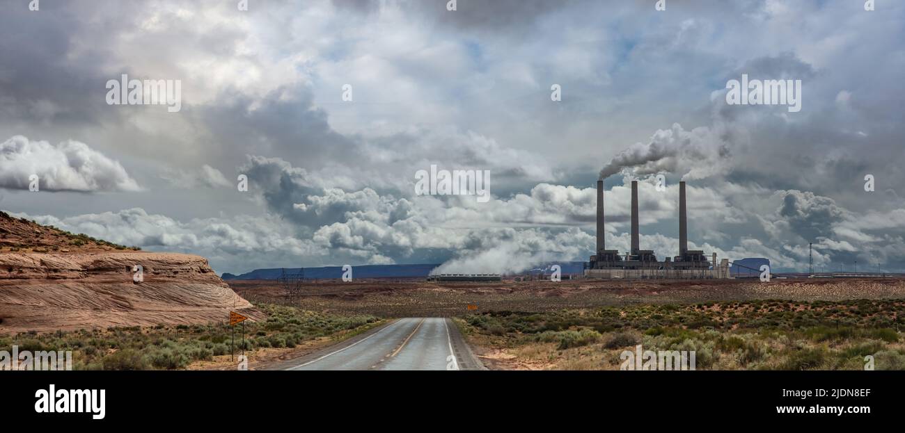 Highway going to Page Arizona power plant. Winding road, passing through American desert, sky with clouds background, sunny spring day, USA. Stock Photo