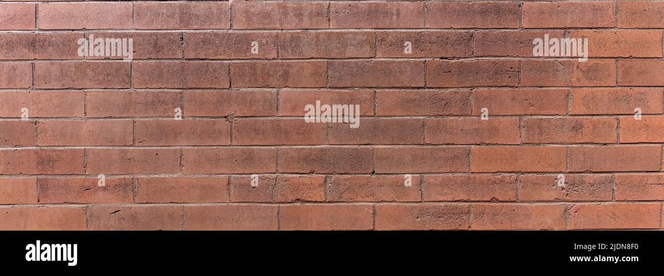 Brickwall background texture, close up view. Brickwork with row of red brown color bricks, horizontal geometric design, banner. Building facade detail Stock Photo