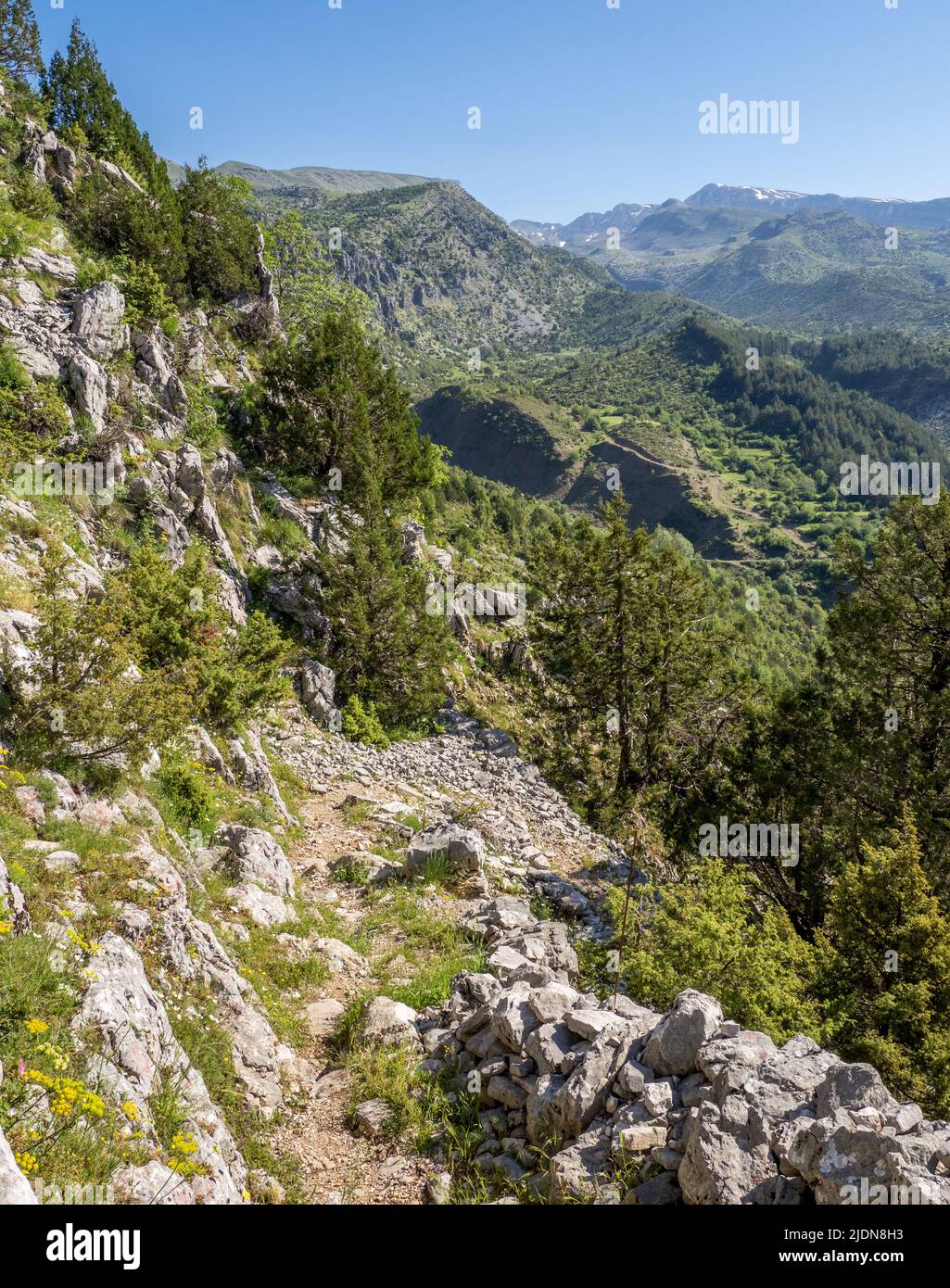 Steep path above the village of Tsepelovo in the Zagori region of northern Greece with Mount Timfi and Gamila peak in the distance Stock Photo