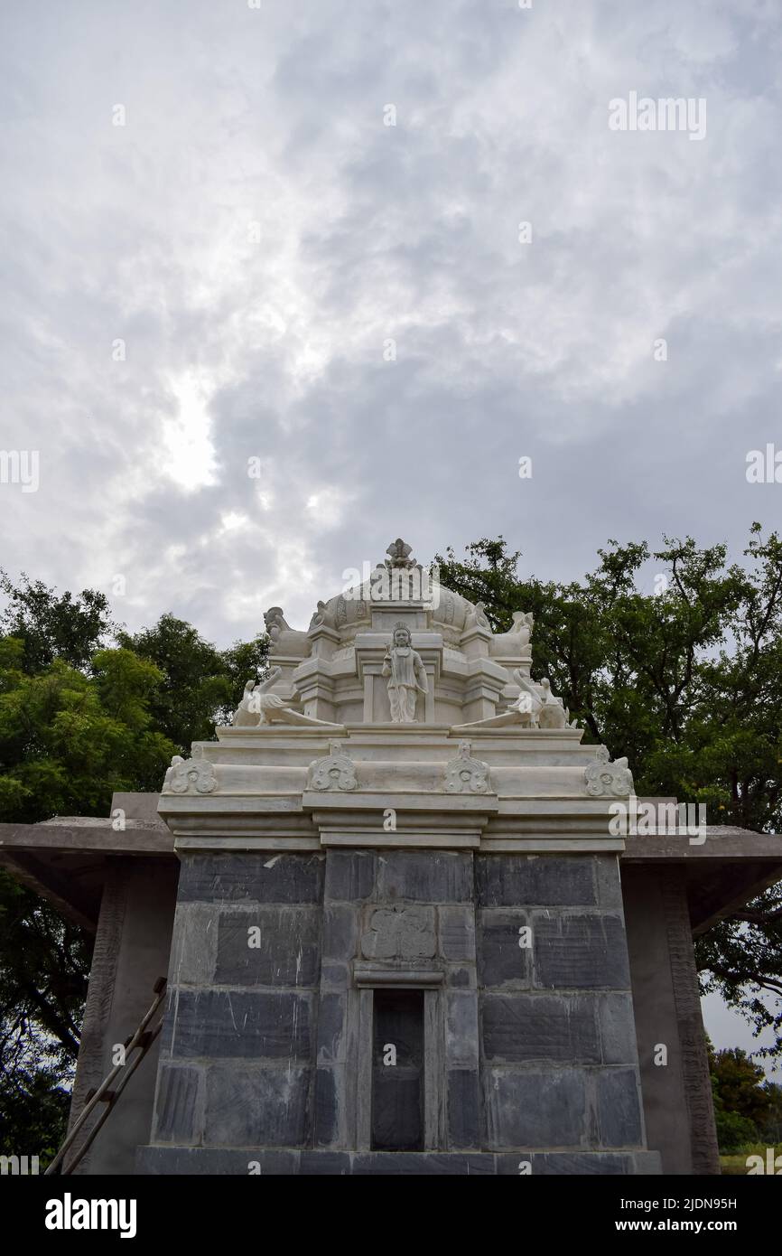 Indian small marble temple and the sky. Concept -Hindu Devotion. Stock Photo