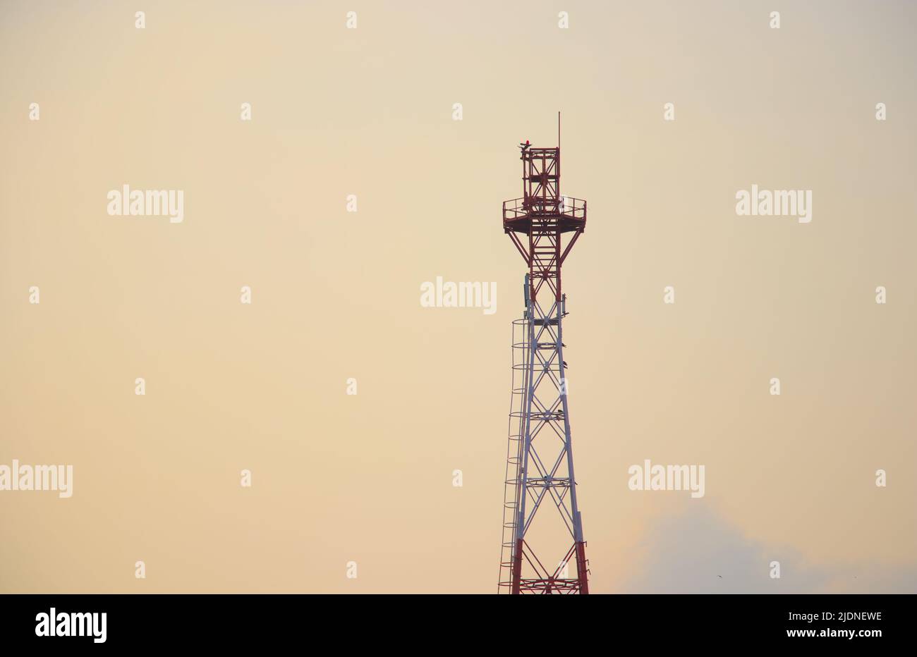 Railway communication tower in evening sky Stock Photo