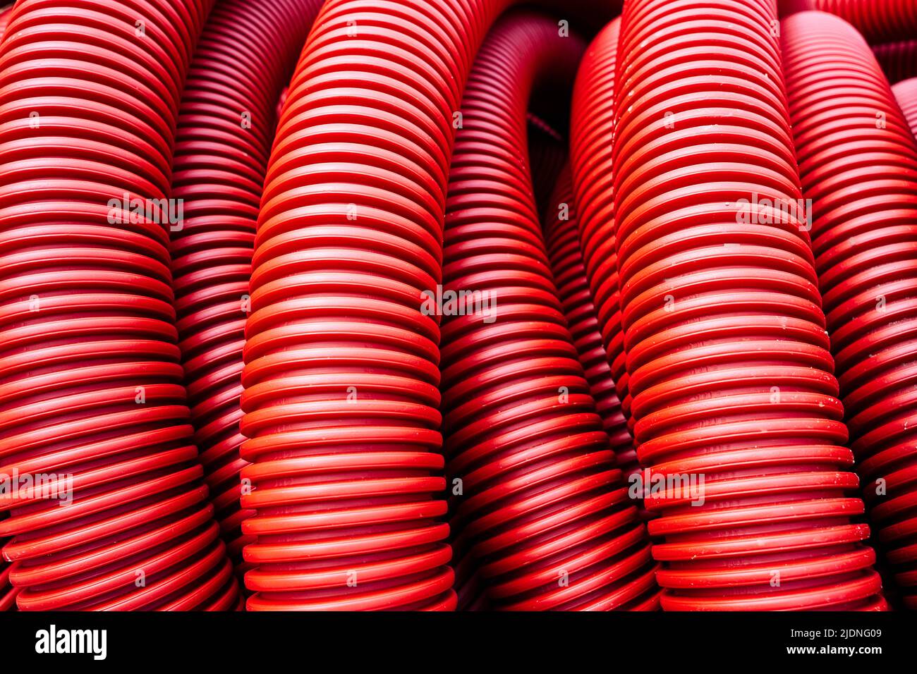 red corrugated pvc pipe for underground electrical cable laying Stock Photo