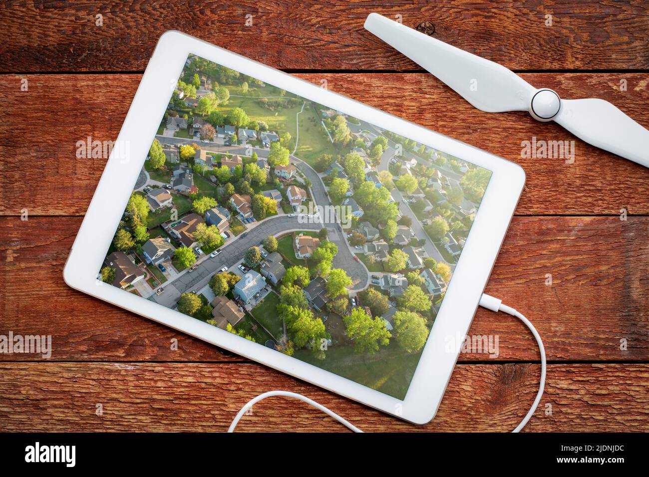 spring sunrise over residential area of Fort Collins in northern Colorado with streets after asphalt crack sealing, reviewing an aerial image on a dig Stock Photo