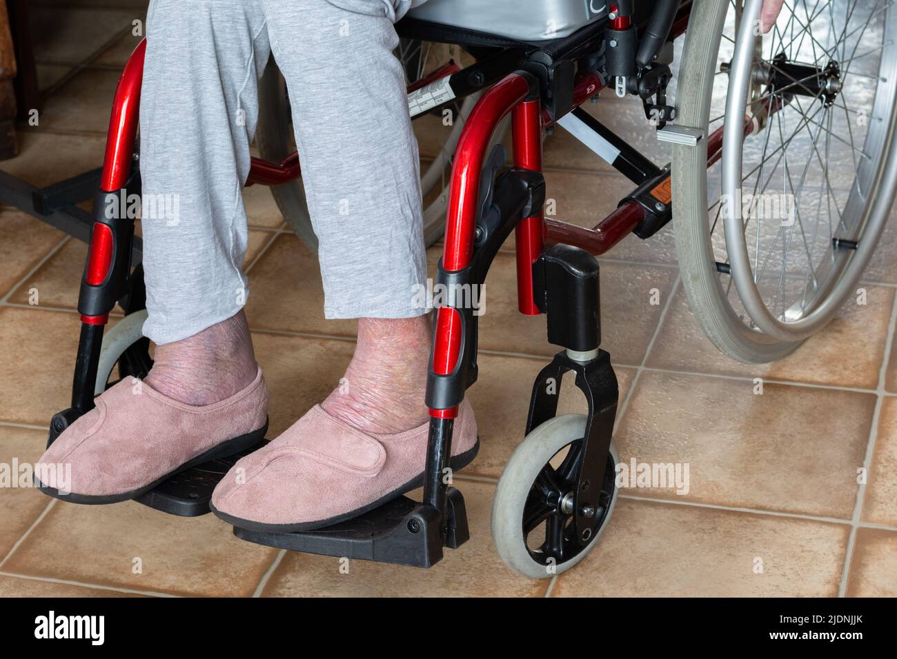 Wheelchair. Elderly person, view of the legs and wheels of the chair