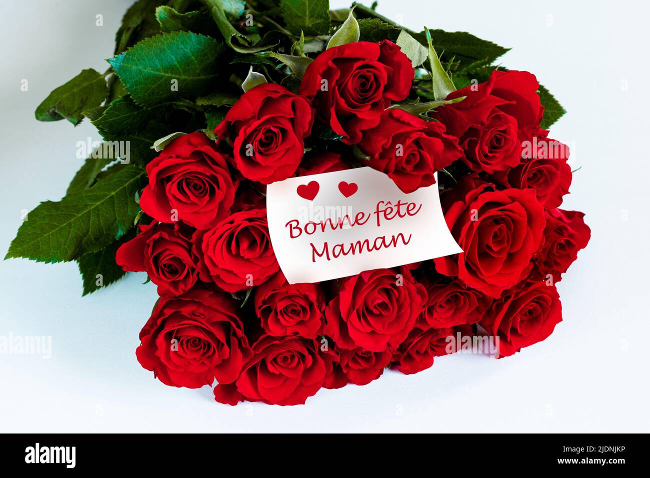 Bouquet of red roses. With "Bonne Fête Maman" card in French Stock