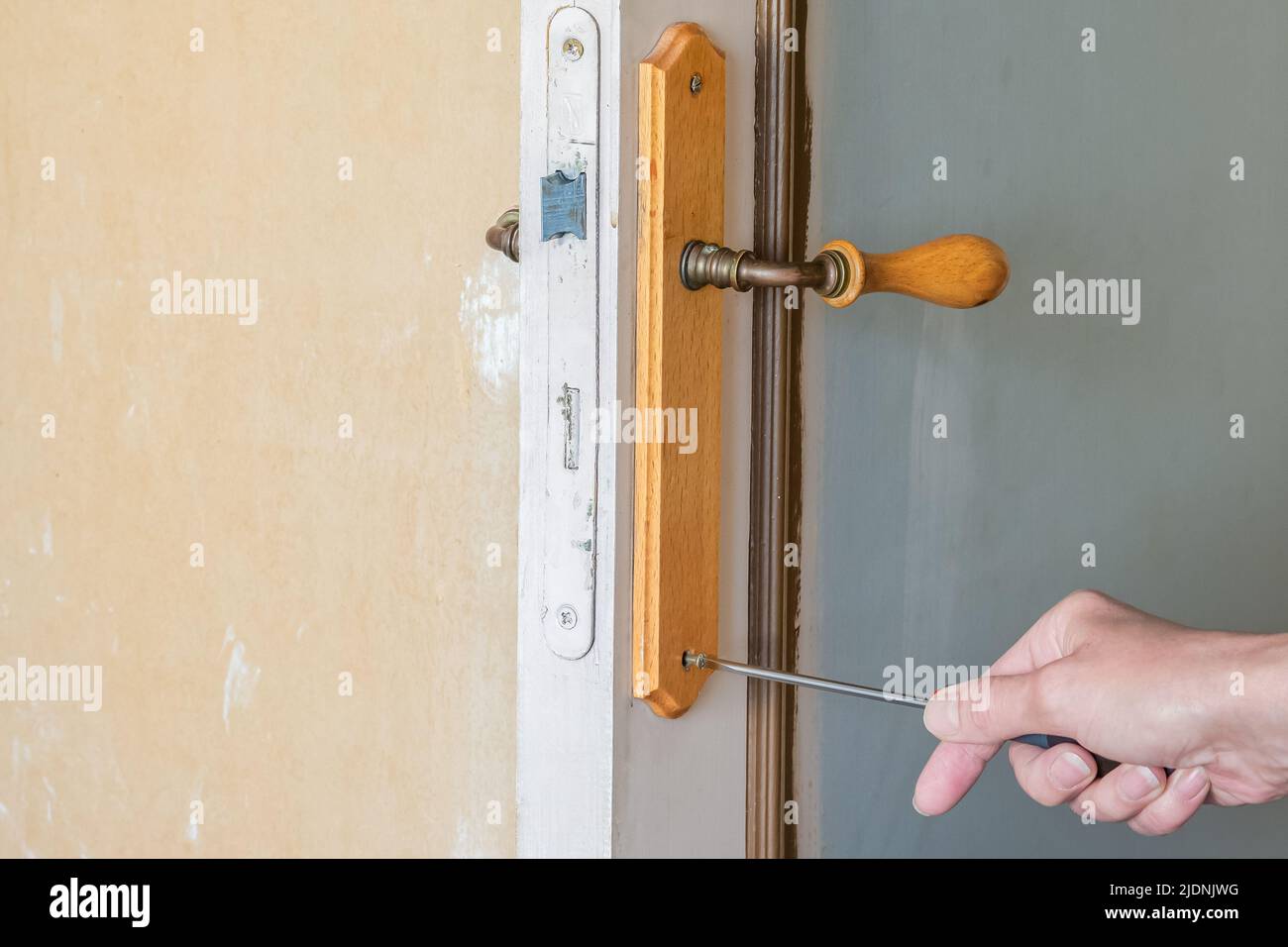 Interior renovation. Replacement of a door lock and handle Stock Photo ...