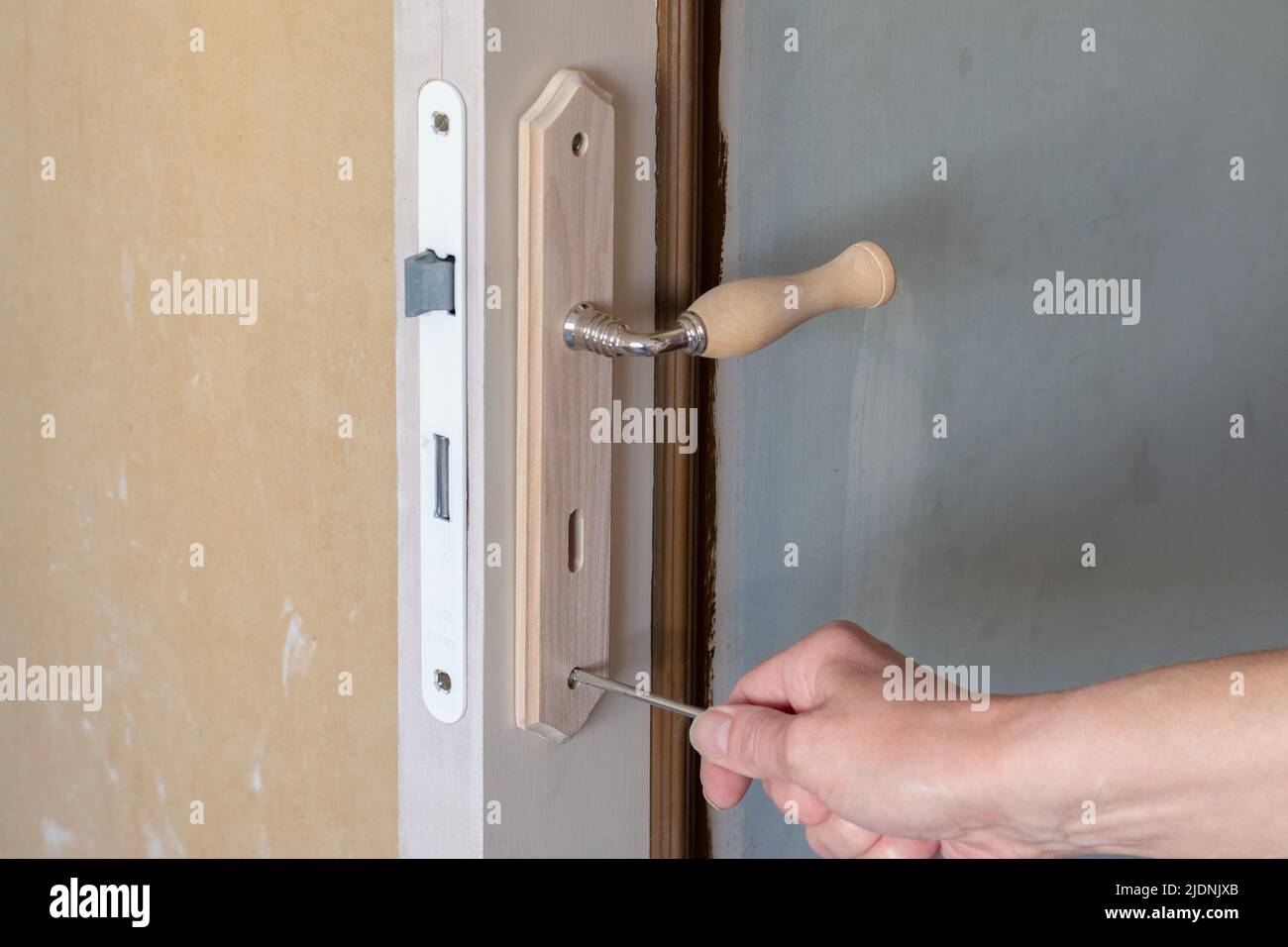 Interior renovation. Replacement of a door lock and handle Stock Photo ...