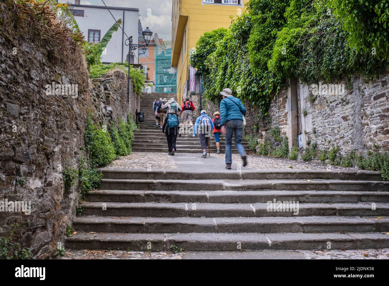 Spain, Galicia, Sarria. Pilgrims Walking Up and Out of Sarria on the