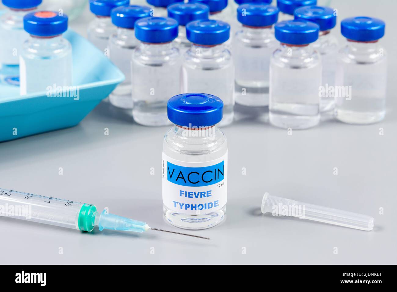 Typhoid fever vaccine. Written in French. Vaccine vials and syringe