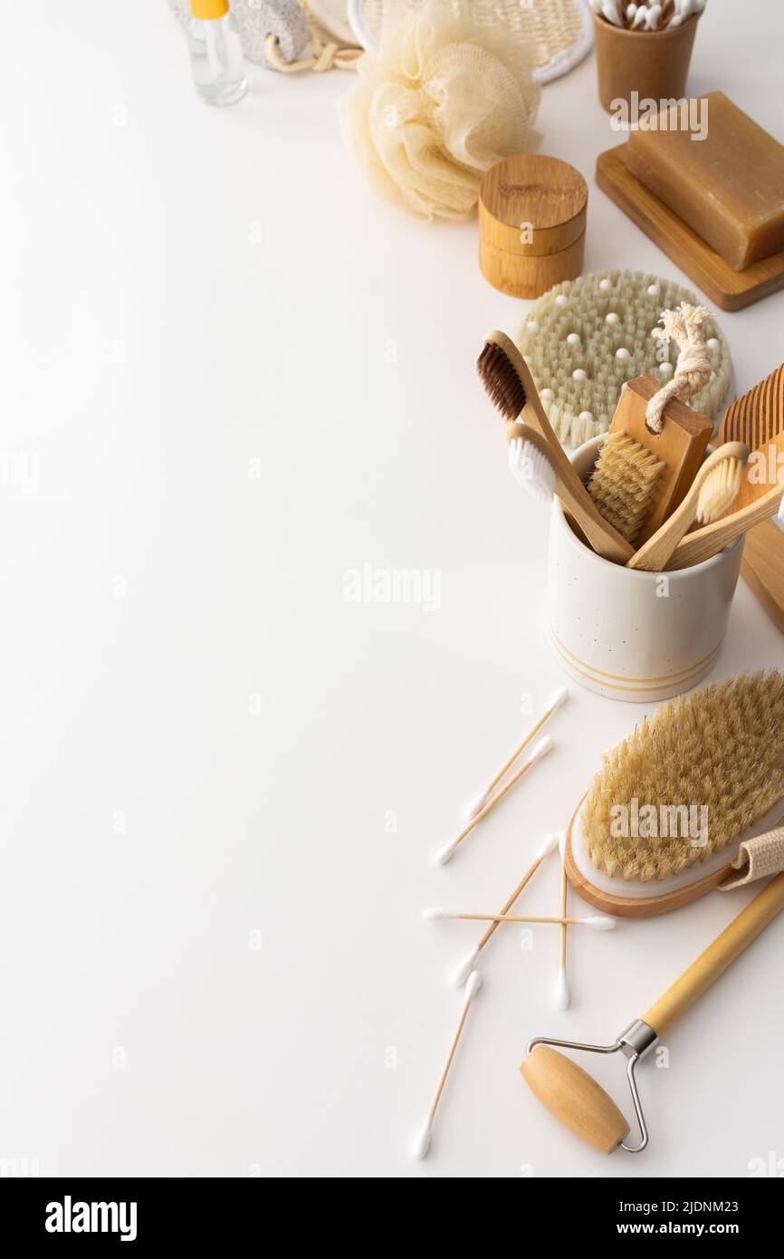 Wooden toothbrushes with natural bristles in a ceramic glass, face and skin care products, bath accessories, spa and beauty concept Stock Photo