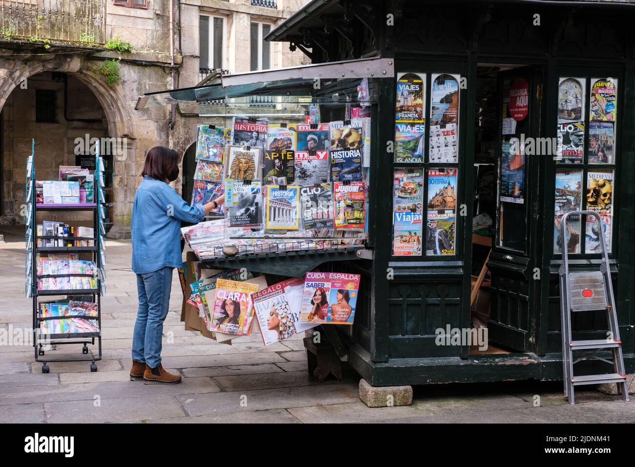 Spain, Santiago de Compostela, Galicia. Customer at a Newsstand. Stock Photo
