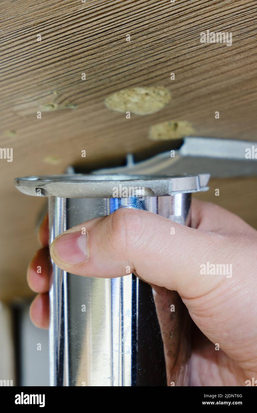 Broken leg of an office desk, repair of furniture made of wood and