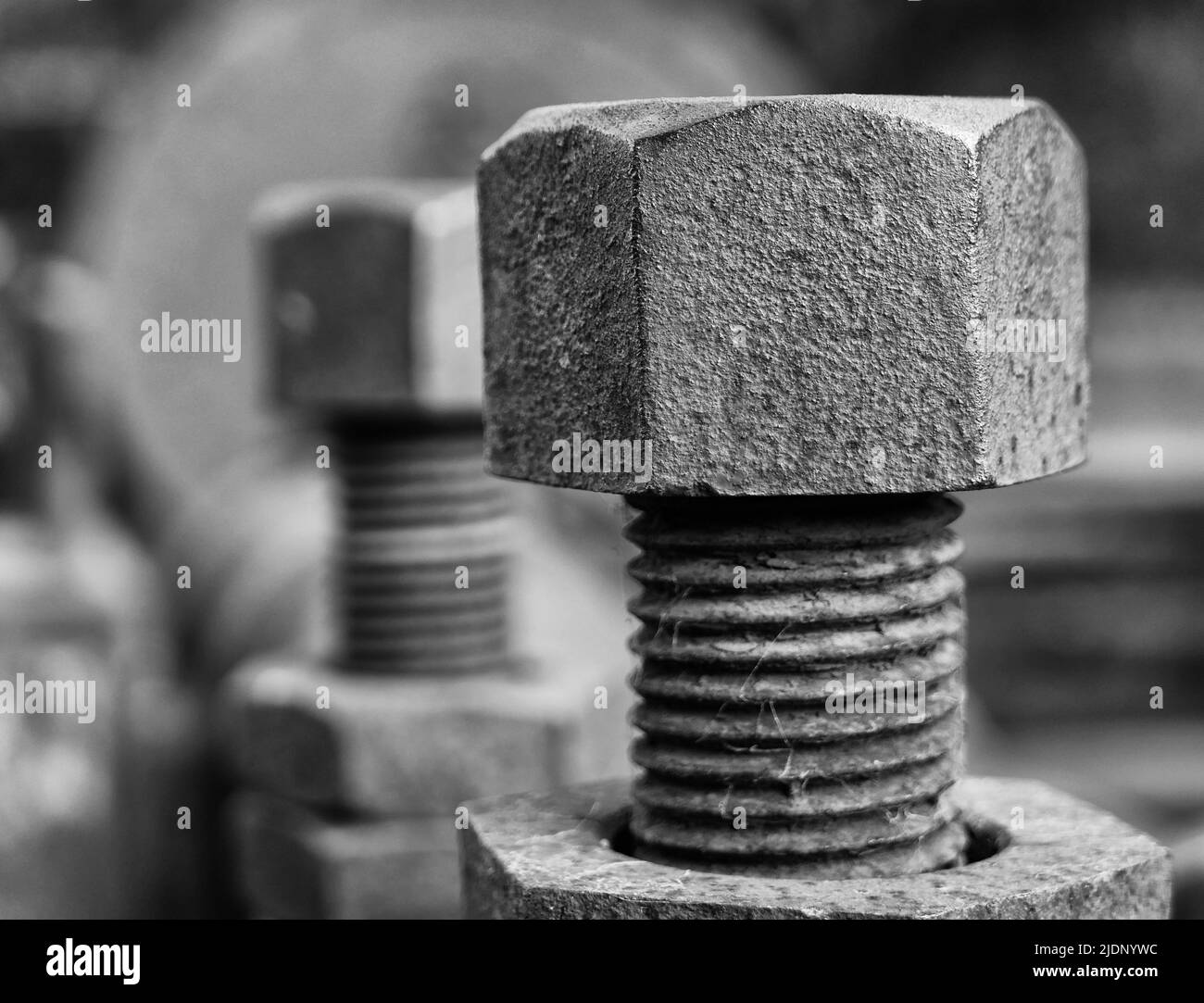 Black and white close up of a nut and bolt partly unscewed Stock Photo