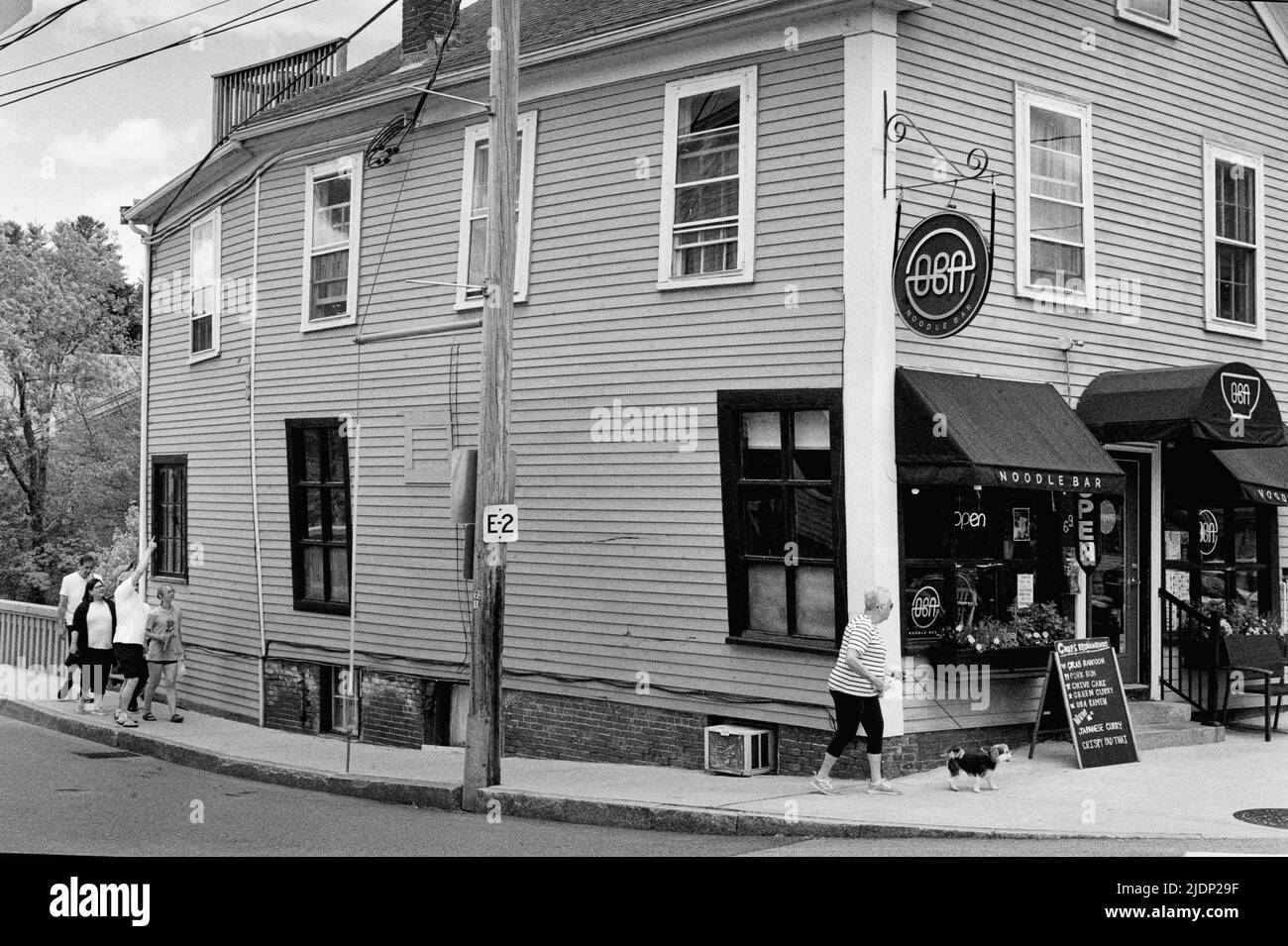 A tourist points to historic building that appears to be bulging at the seams and ready to collapse at any time. It is located at the corner of String Stock Photo