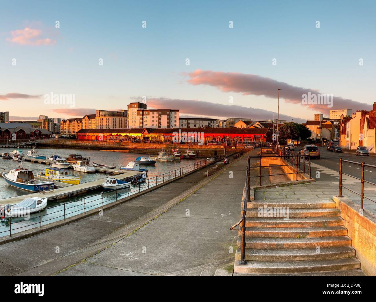 Boats moored at Newhaven Harbour with a Sunset, Edinburgh, Scotland, UK Stock Photo