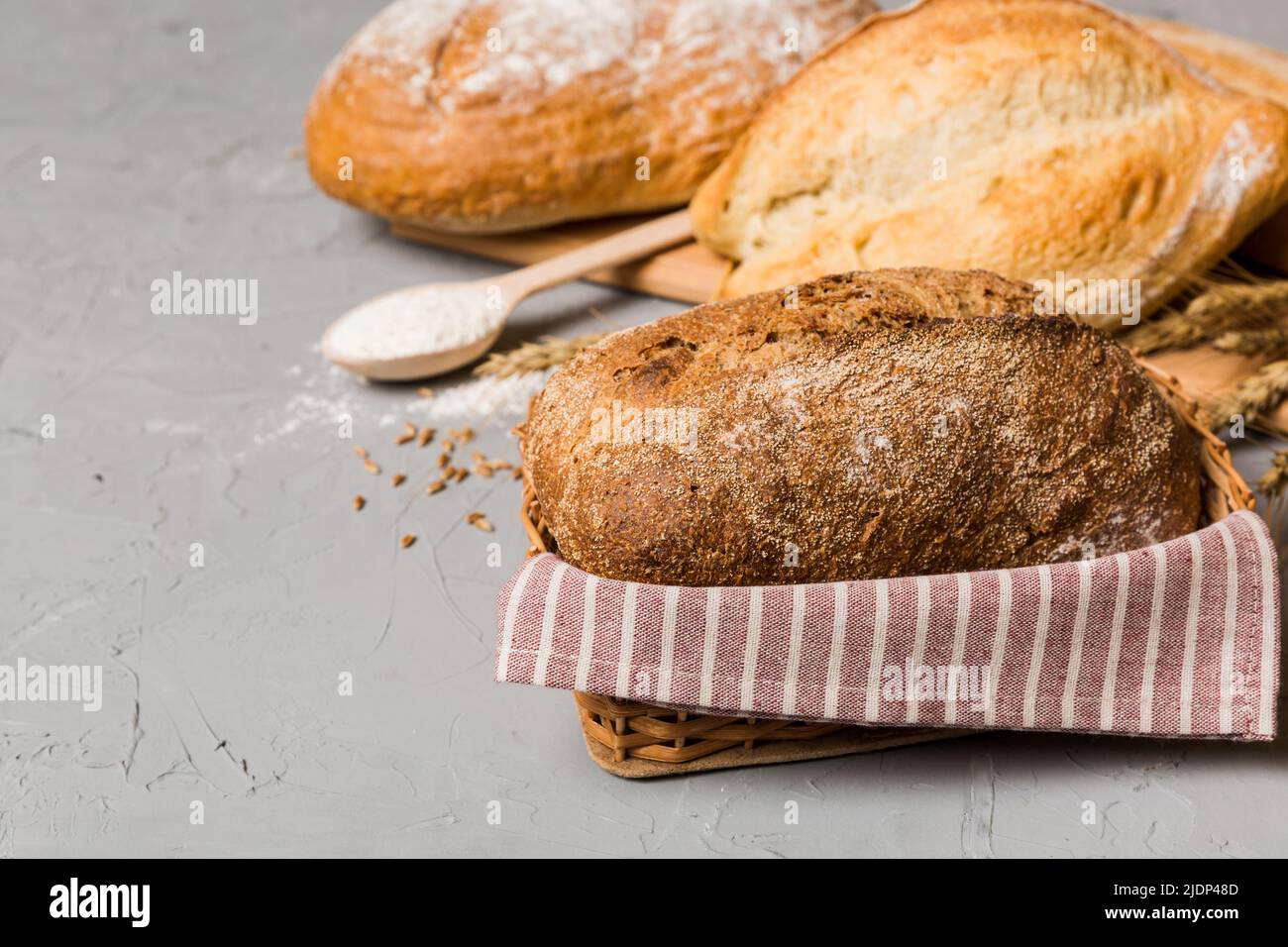 Homemade natural breads. Different kinds of fresh bread as background, perspective view with