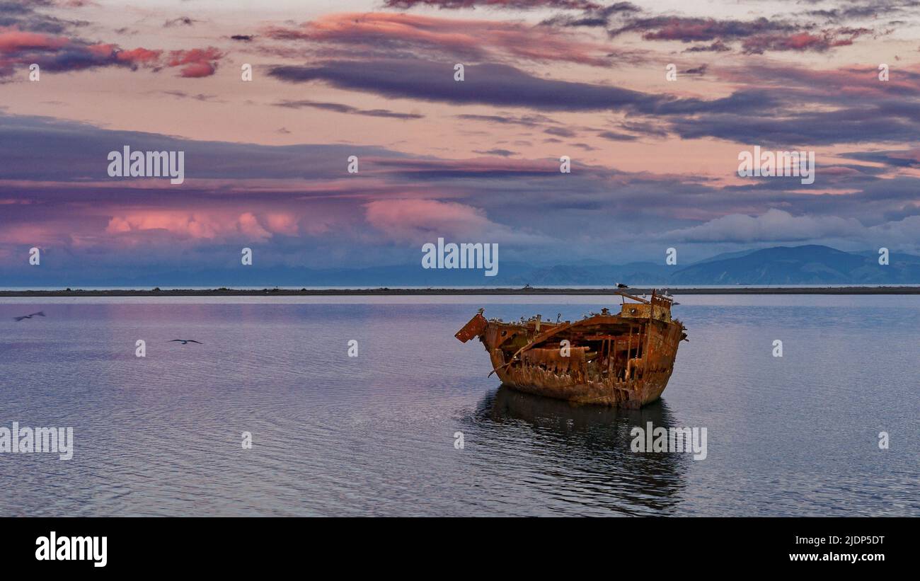 Janie Seddon shipwreck glowing in the evening sunlight at high tide, Motueka, Tasman region, Aotearoa / New Zealand Stock Photo