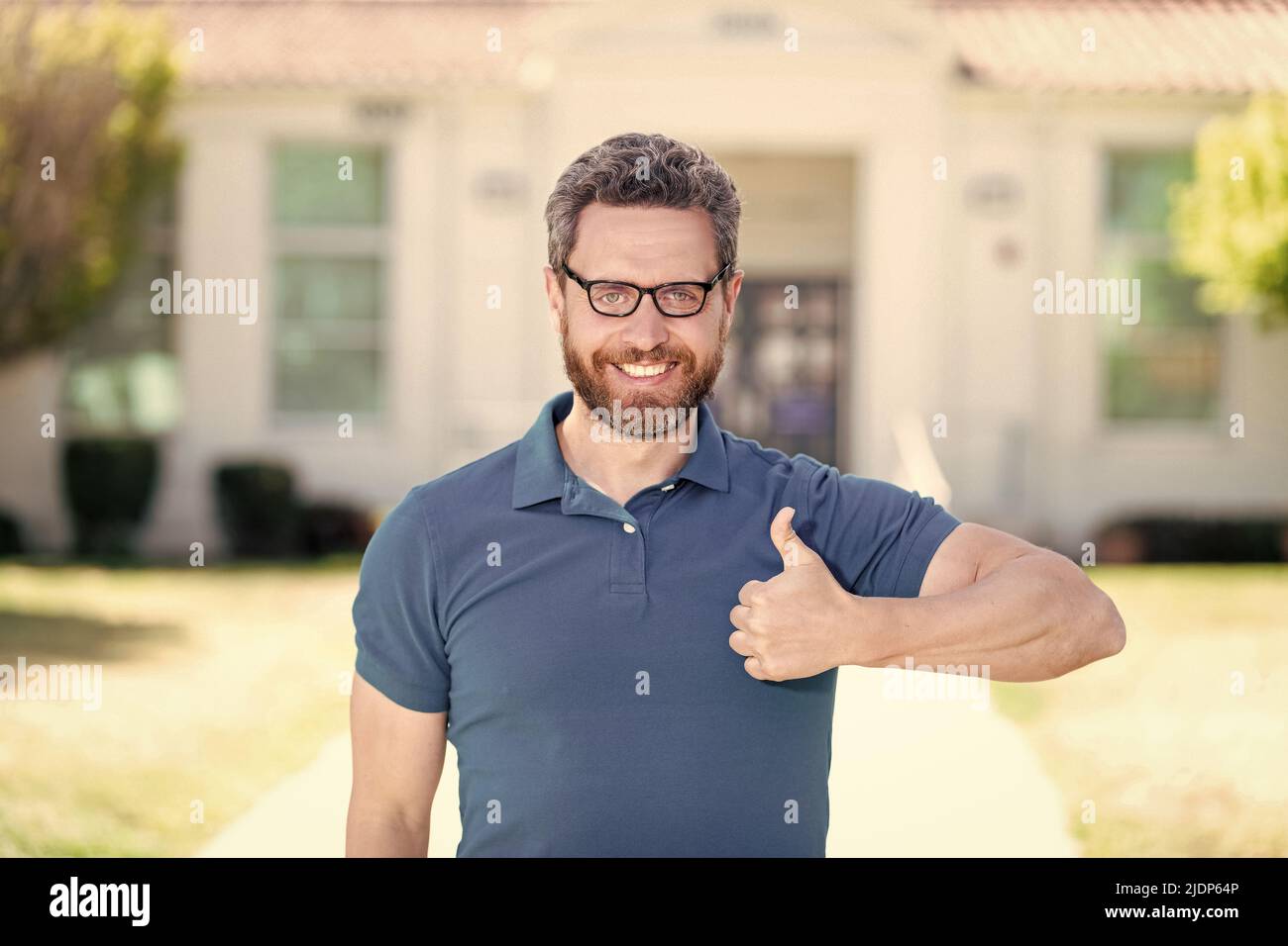 good eye health of happy guy in glasses with thumb up gesture, eye care Stock Photo