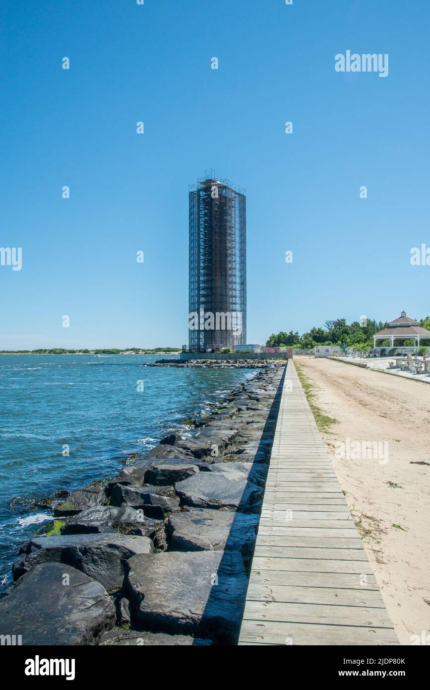 June 19, 2022, Barnegat Light, NJ USA The iconic Barnegat Lighthouse on Long Beach Island, New Jersey is shrouded in scaffolding for restoration and painting, hiding the distinctive landmark from view. Stock Photo