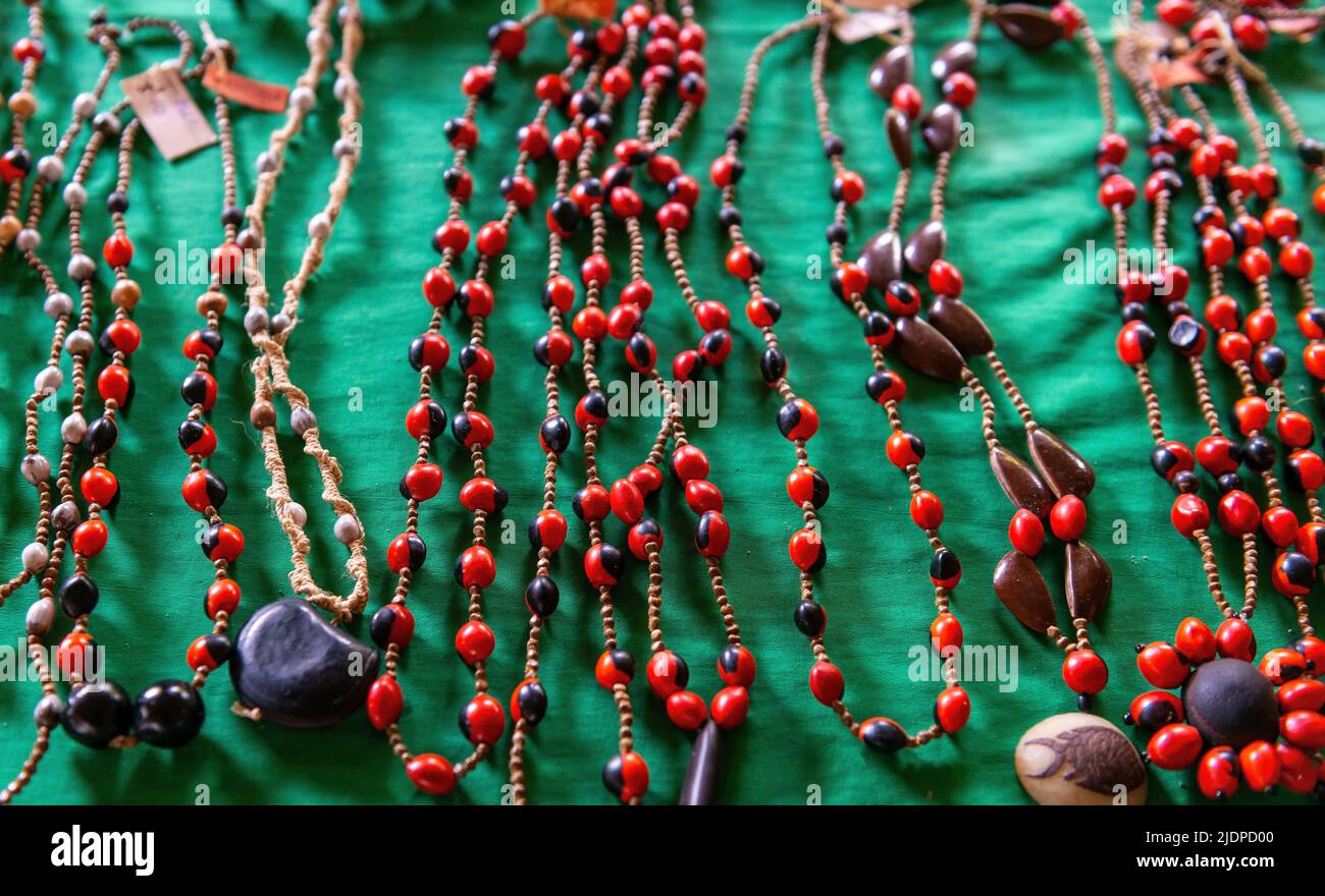 Organic handicrafts from the Amazon rainforest with huayruro seeds (Ormosia coccinea) necklaces, Yasuni national park, Ecuador. Stock Photo