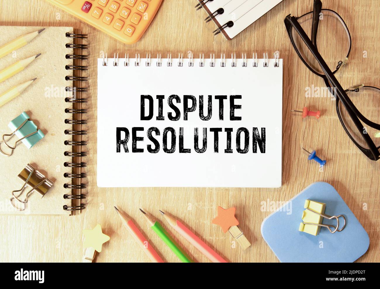 Man holds wooden puzzles with the words Dispute Resolution. Law and justice concept. Litigation, arbitration, mediation. ADR. Search for compromises. Stock Photo