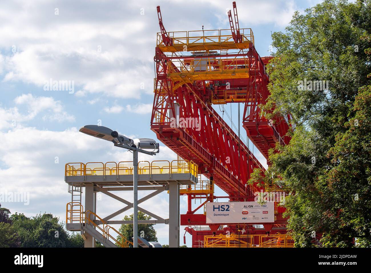 Denham, Buckinghamshire, UK. 22nd June, 2022. A 700 tonne orange coloured launch girder machine called Dominique has started to winch some of the pre cast concrete bridge segments into place onto the first of 56 pier segments for the HS2 High Speed 2 Colne Valley Viaduct. The Colne Valley Viaduct will be longest railway bridge in the UK. Credit: Maureen McLean/Alamy Live News Stock Photo