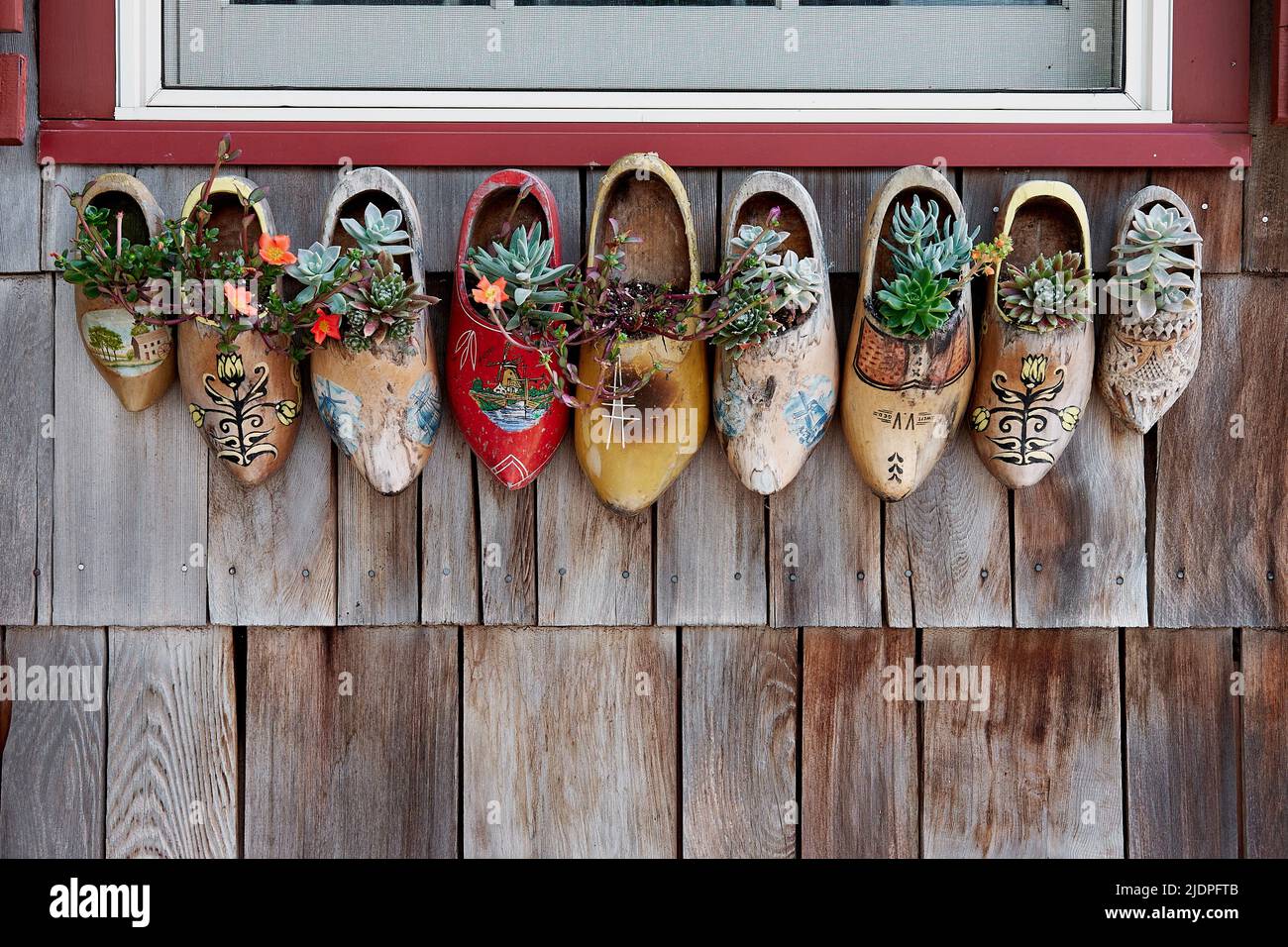 Festive wooden Dutch shoes are displayed below a residential window in Lewes, Delaware.  Lewes was founded as a Dutch trading post in 1632. Stock Photo
