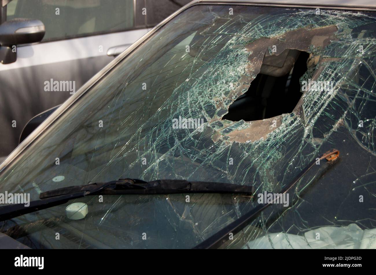 Broken windshield with hole of the car involved in an accident. Stock Photo