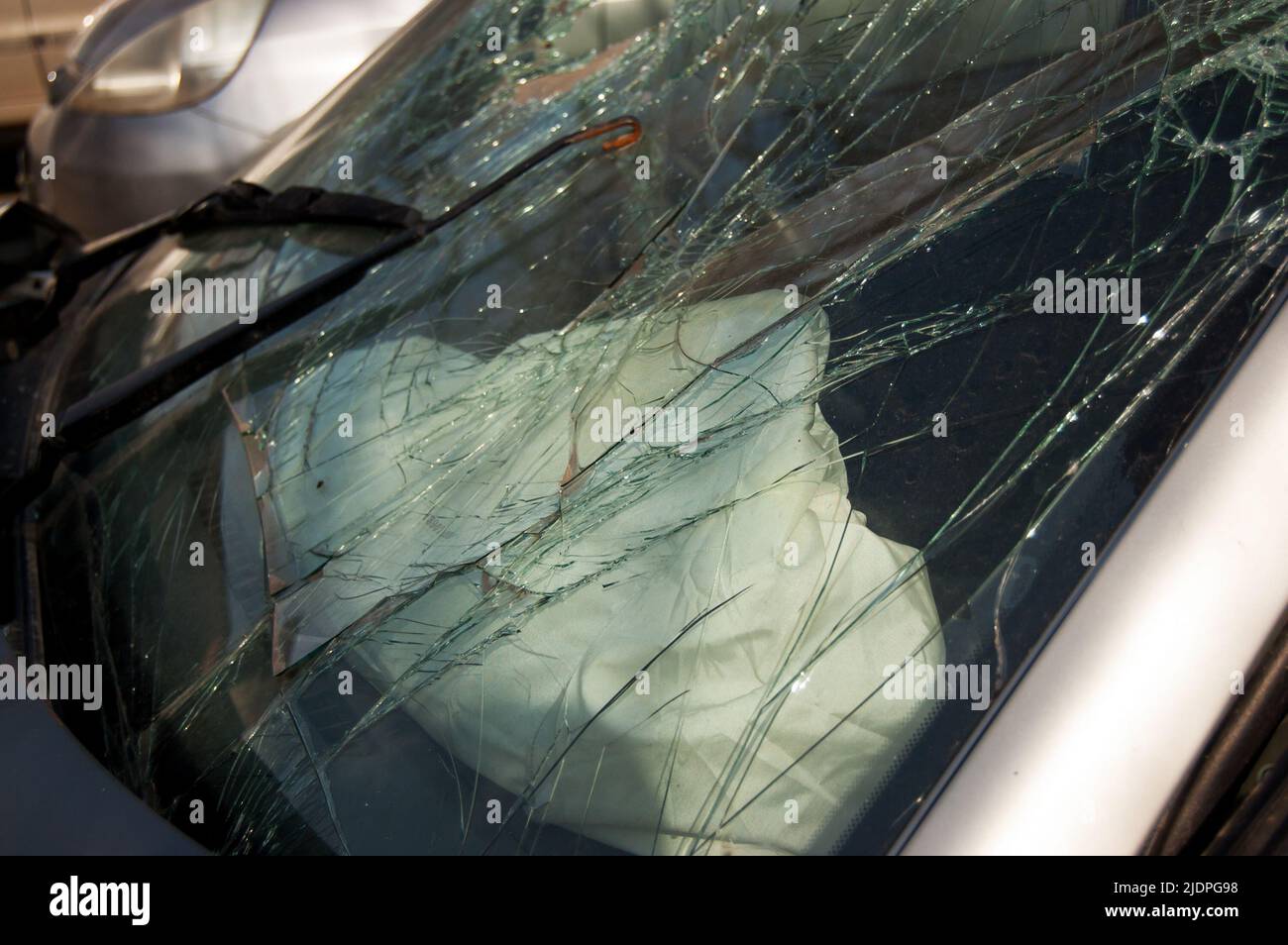 cracked glass of windshield of the car involved in an accident. Stock Photo