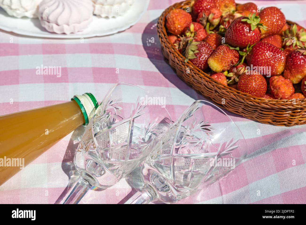 Apple juice, glasses and freshly picked strawberries. Lunch in the fresh air. Stock Photo