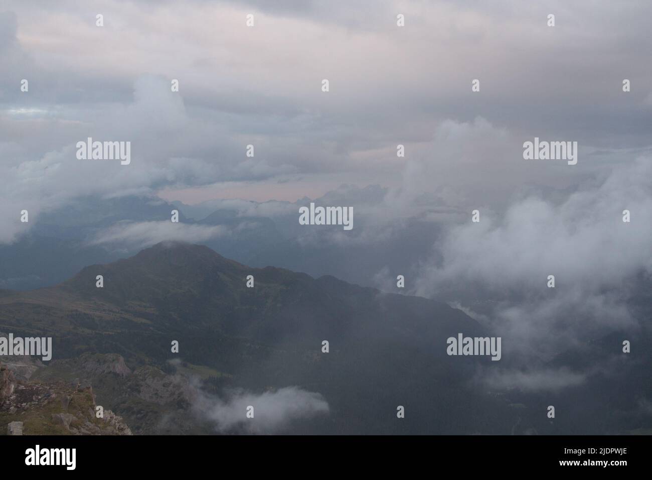 The view of storm clouds at sunset light above mountains Stock Photo ...