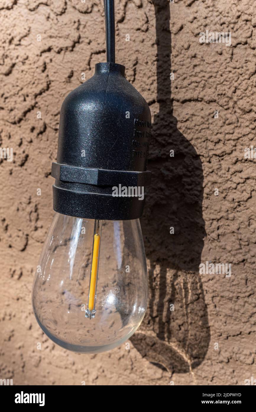 outdoor LED light against a stucco wall Stock Photo