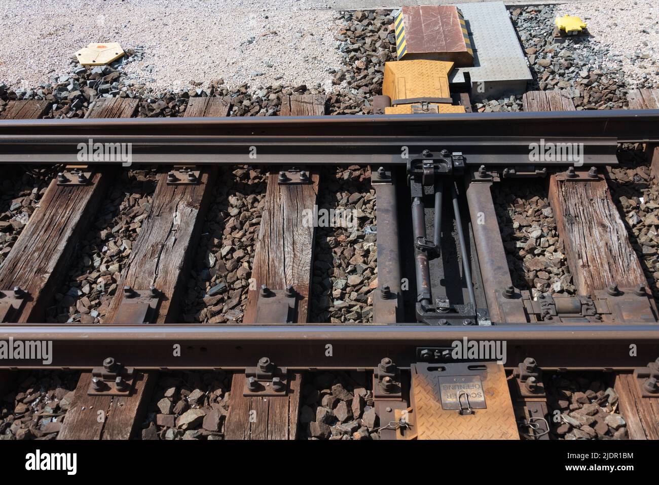 Closeup of a railroad switch with electric actuator for remote control