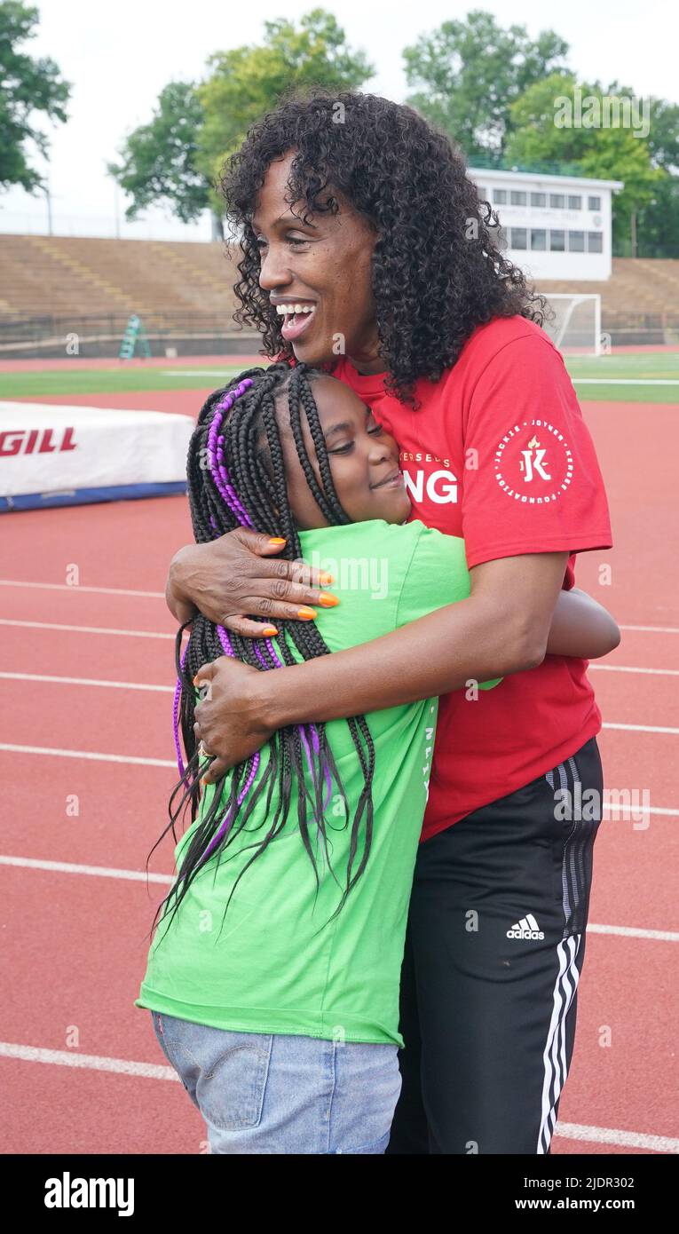 St. Louis, United States. 22nd June, 2022. Six-time Olympic Medalist Jackie Joyner-Kersee hugs a participating child before a run on the campus of Washington University in St. Louis on Wednesday, June 22, 2022. Jackie Joyner-Kersee and other St. Louis Olympians lead hundreds of St. Louis area youth around the track at Francis Olympic Field, site of the 1904 Olympic Games, in observance of World Olympic Day. Photo by Bill Greenblatt/UPI Credit: UPI/Alamy Live News Stock Photo