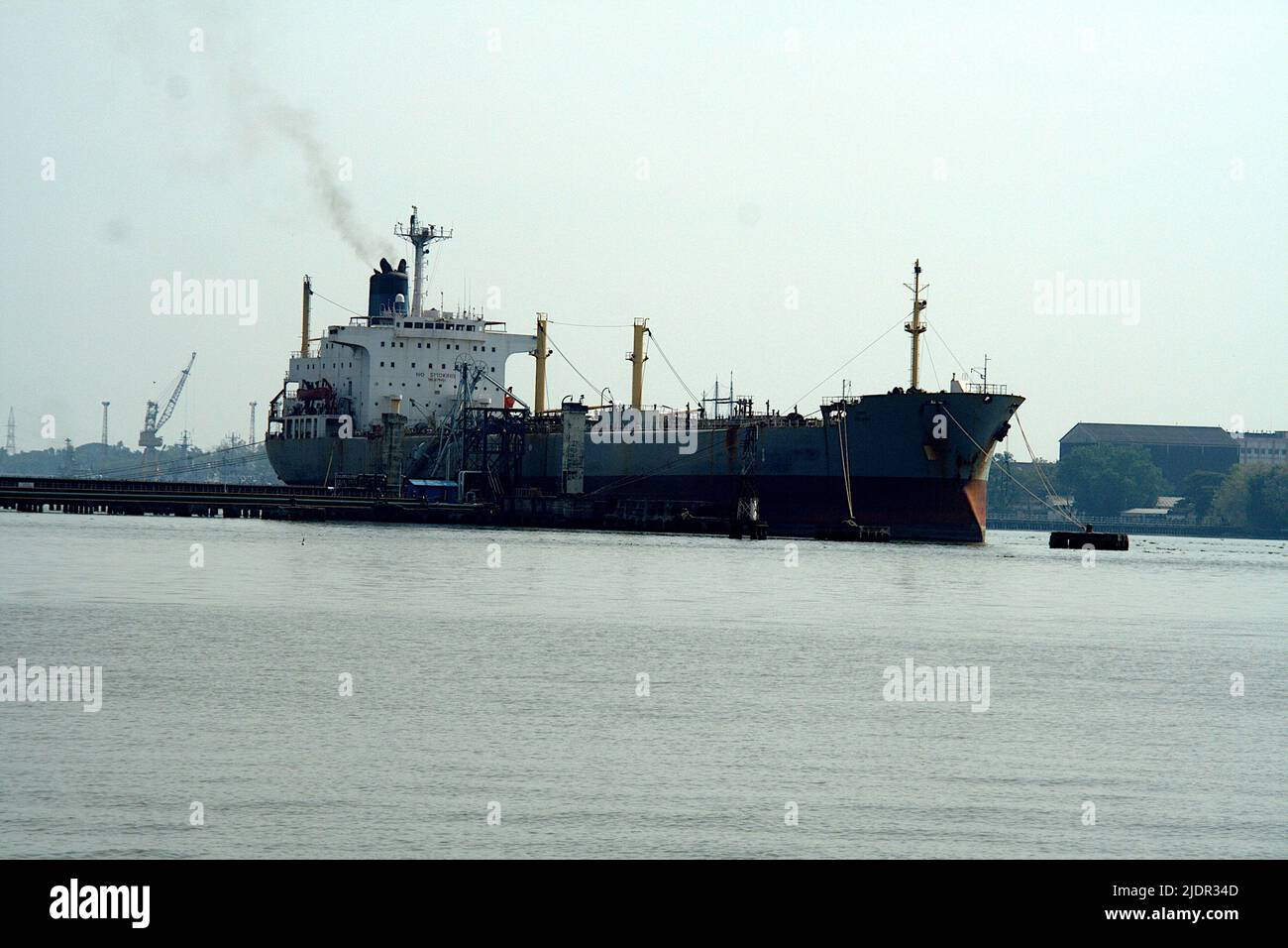 View of ship anchored in middle of sea water near Kochi in Kerala, India, Asia Stock Photo