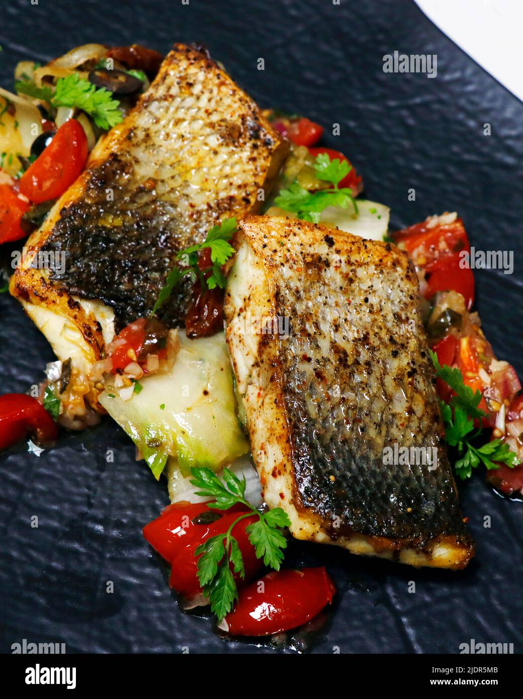 pan seared or fried atlantic sea bass fish fillet with mediterranean vegetable Stock Photo Alamy