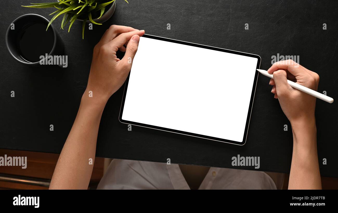 A male college student or male freelancer using portable digital tablet and stylus pen to design