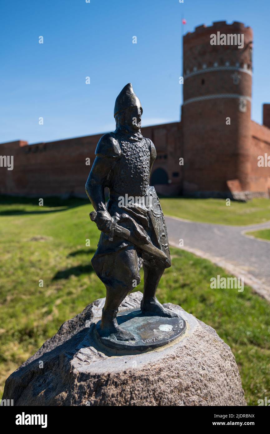 Knight Cieszko miniature bronze sculpture in front of Castle of the Masovian Dukes in Ciechanow, Poland. Stock Photo