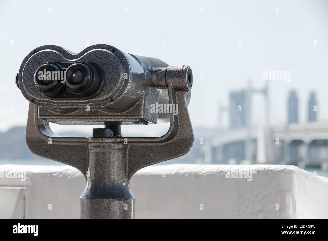 Binocular telescope for tourists mounted in the modern city, close up