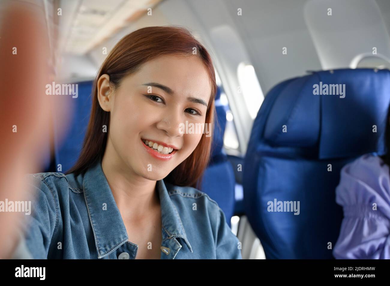 Beautiful young asian female travel blogger taking selfie or recording