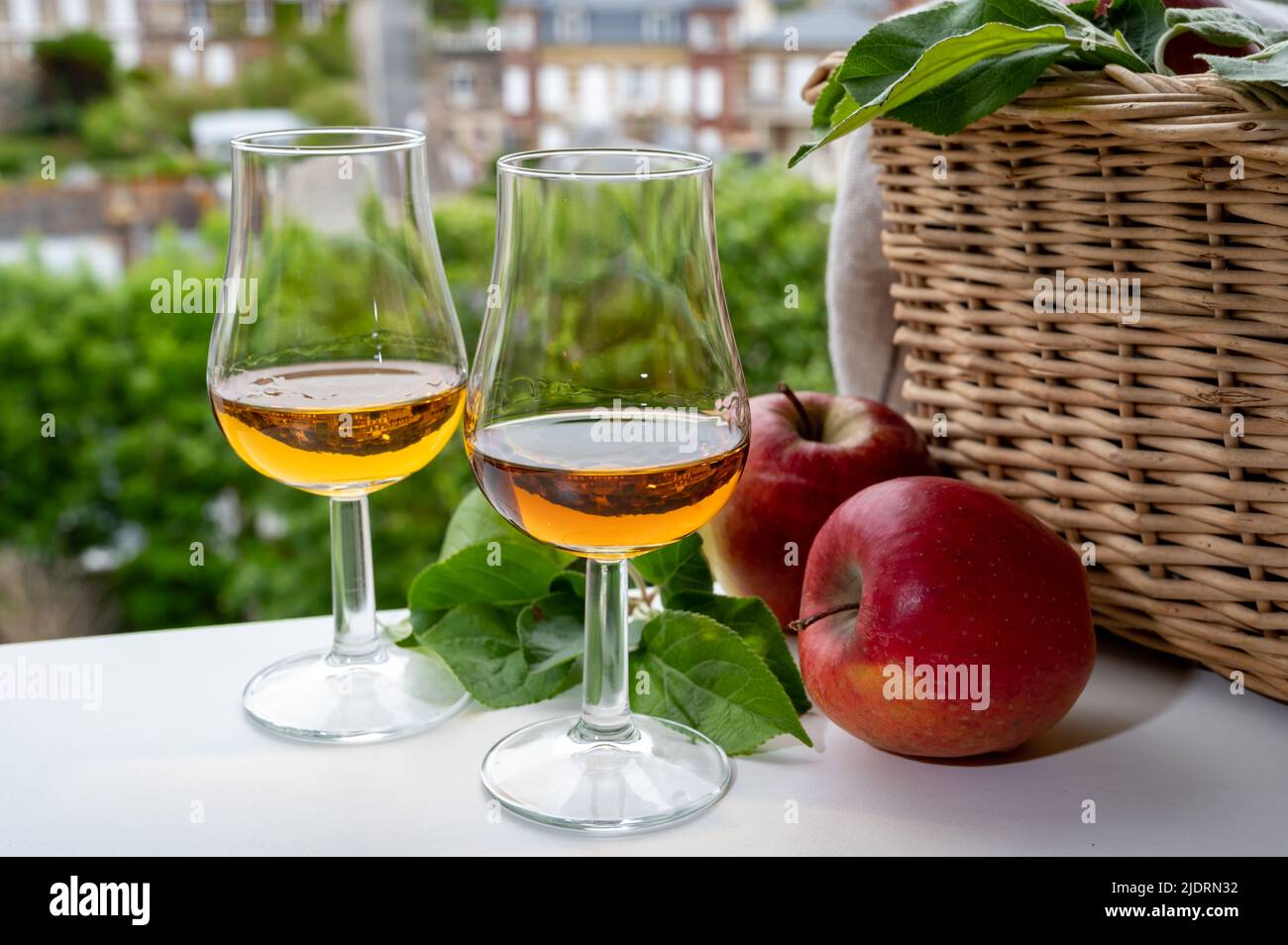 Tasting of strong alcoholic drink calvados made from apples in Normandy and  view on old houses in Norman village, Calvados region, France Stock Photo -  Alamy