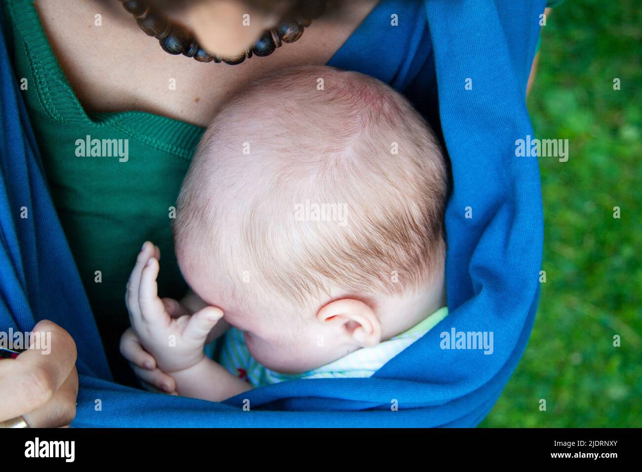 Newborn and mother. A newborn baby sleeps on his mother's lap. Newborn