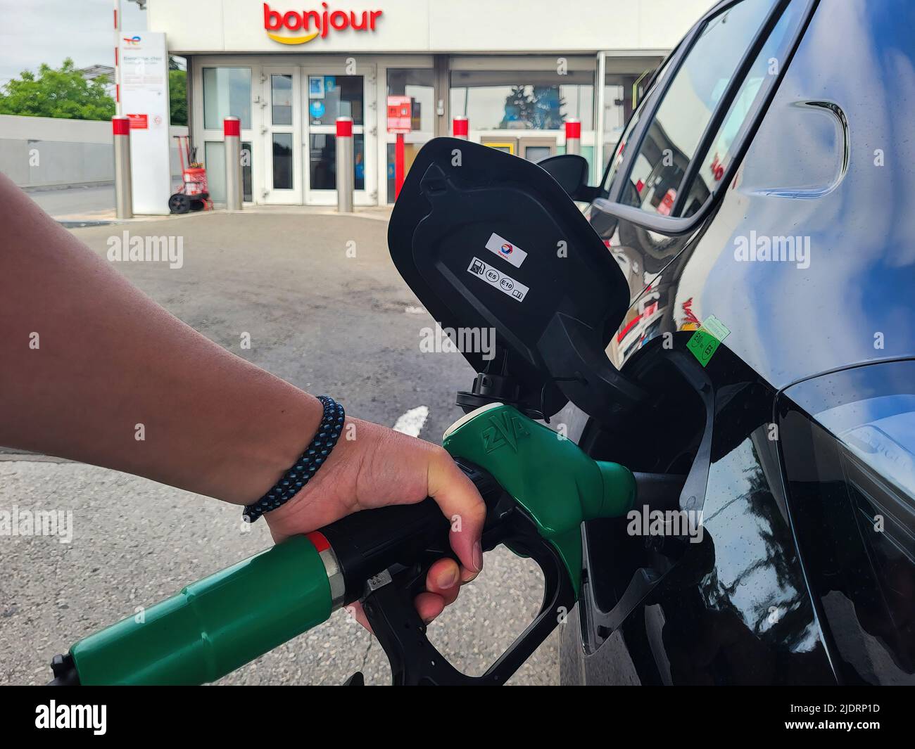 PARIS, FRANCE - JUNE 2022: Refueling a car with E10 super at a french gas station Stock Photo