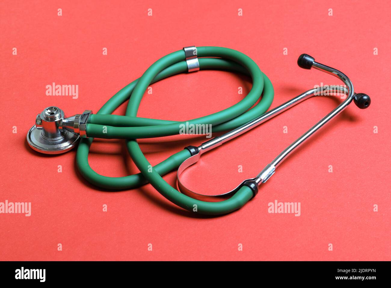 Top view of green stethoscope on colorful background. Medical diagnosis