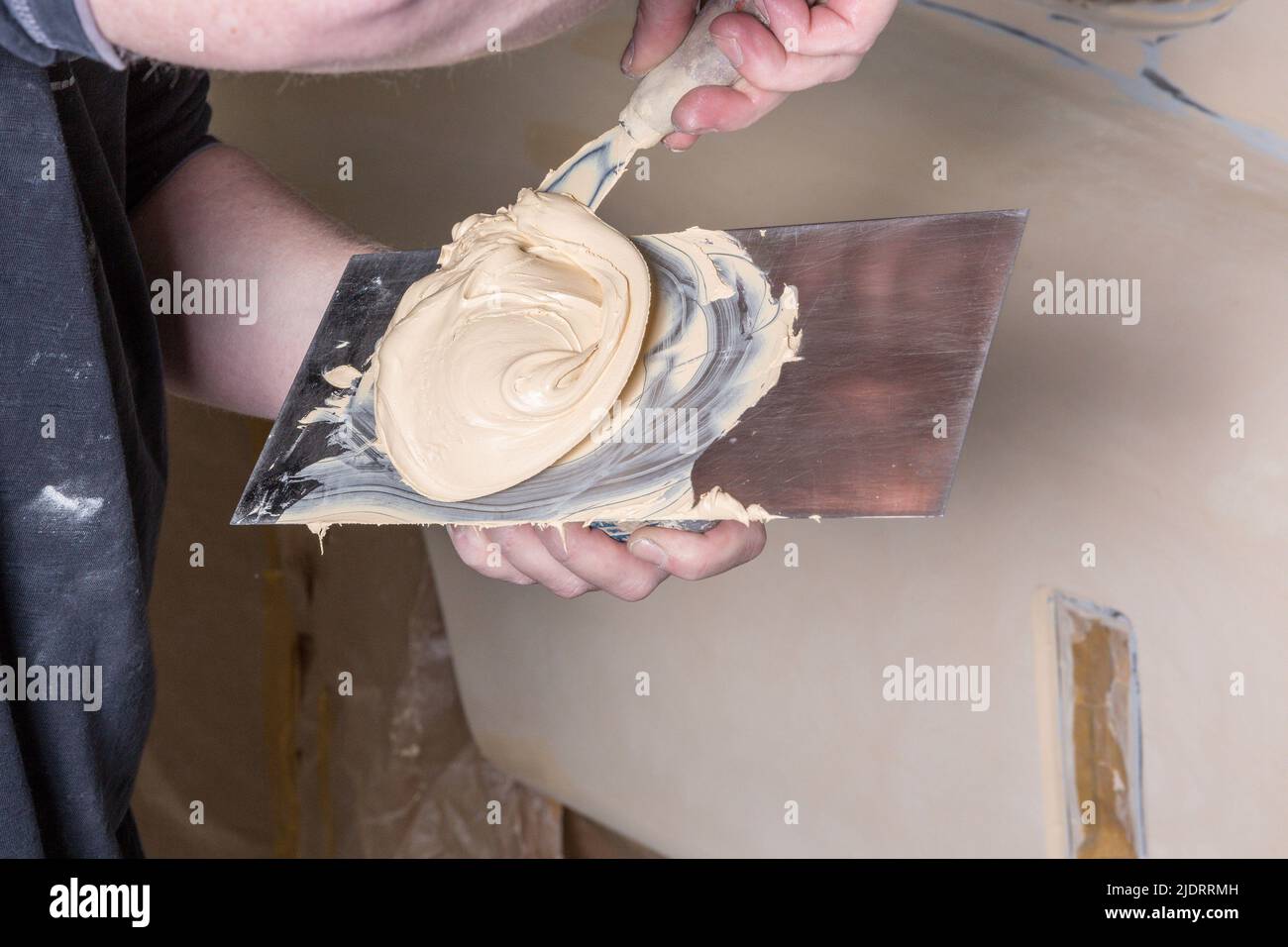 Close-up of using two-component adhesive on a spatula for car restoration Stock Photo